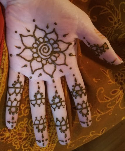 Flower on palm of hand henna design