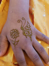 Butterfly and flower henna design on hand