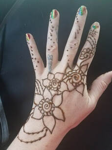 Flower and vines Henna tattoo on hand 10
